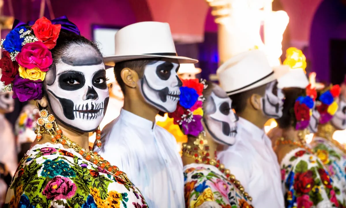 Colorful Day of the Dead celebration with traditional costumes and face paint