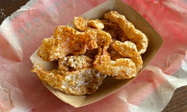 Pork rinds from VooDoo BBQ in Pensacola, crispy fried pork skins served as a Southern-style snack.