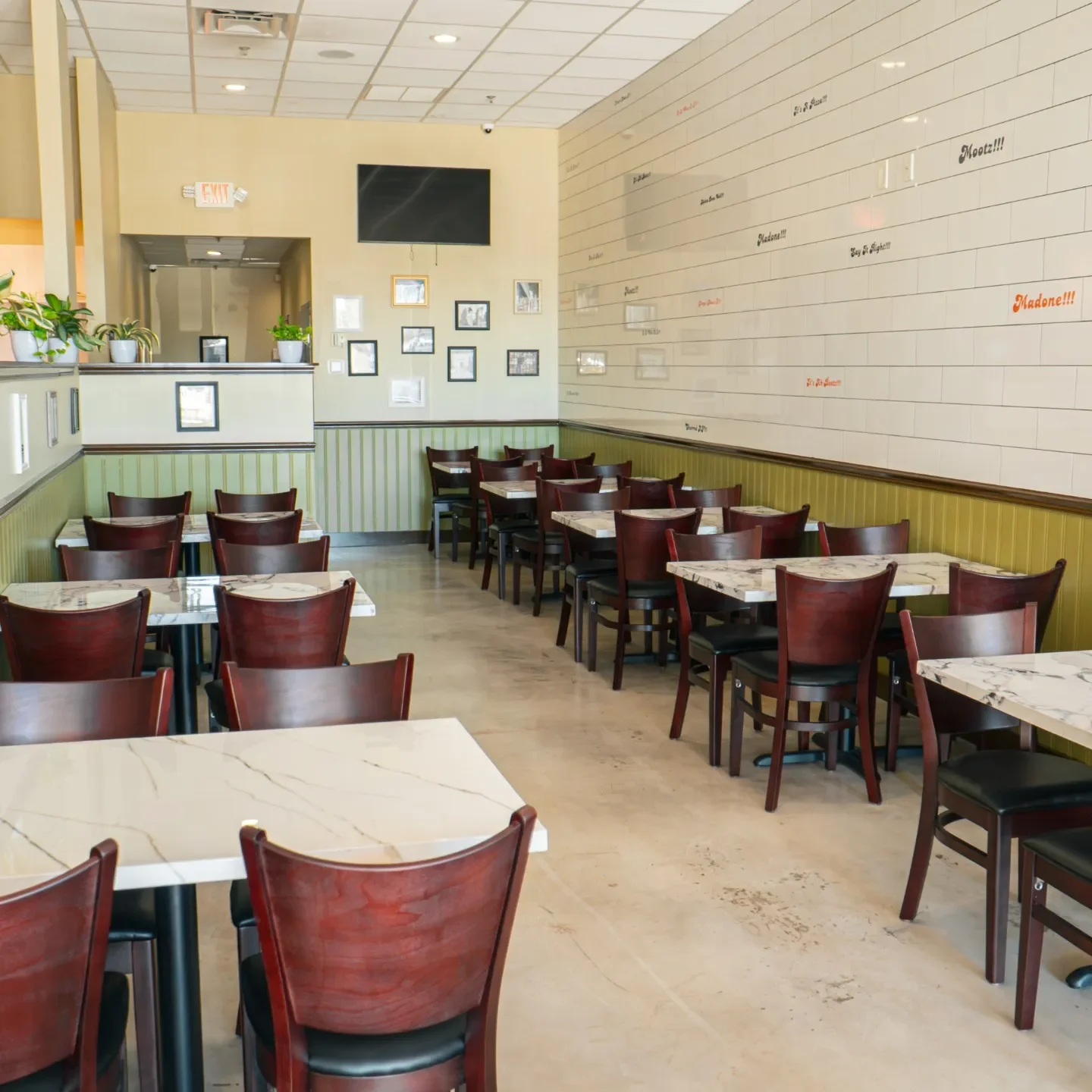 An interior of an Ah Beetz restaurant showcasing tables and chairs