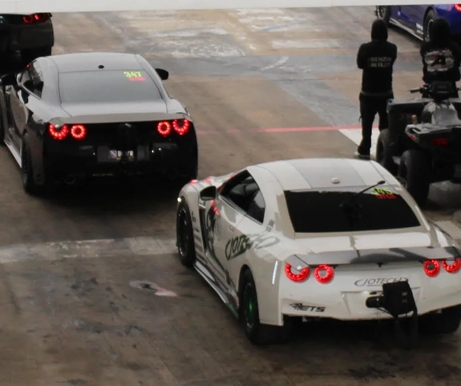 Race cars lined up at a motorsport facility