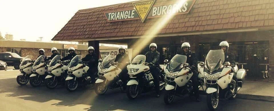 Motorcycle police officers in front of Triangle Burgers restaurant