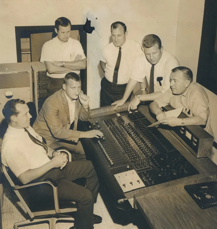 Group of professionals collaborating at a sound mixing console