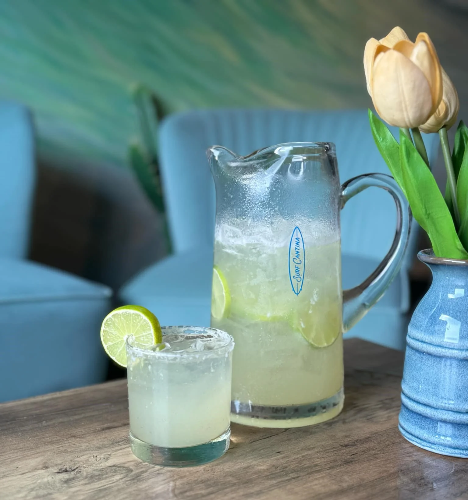 Fresh lime margarita and pitcher served on a restaurant table