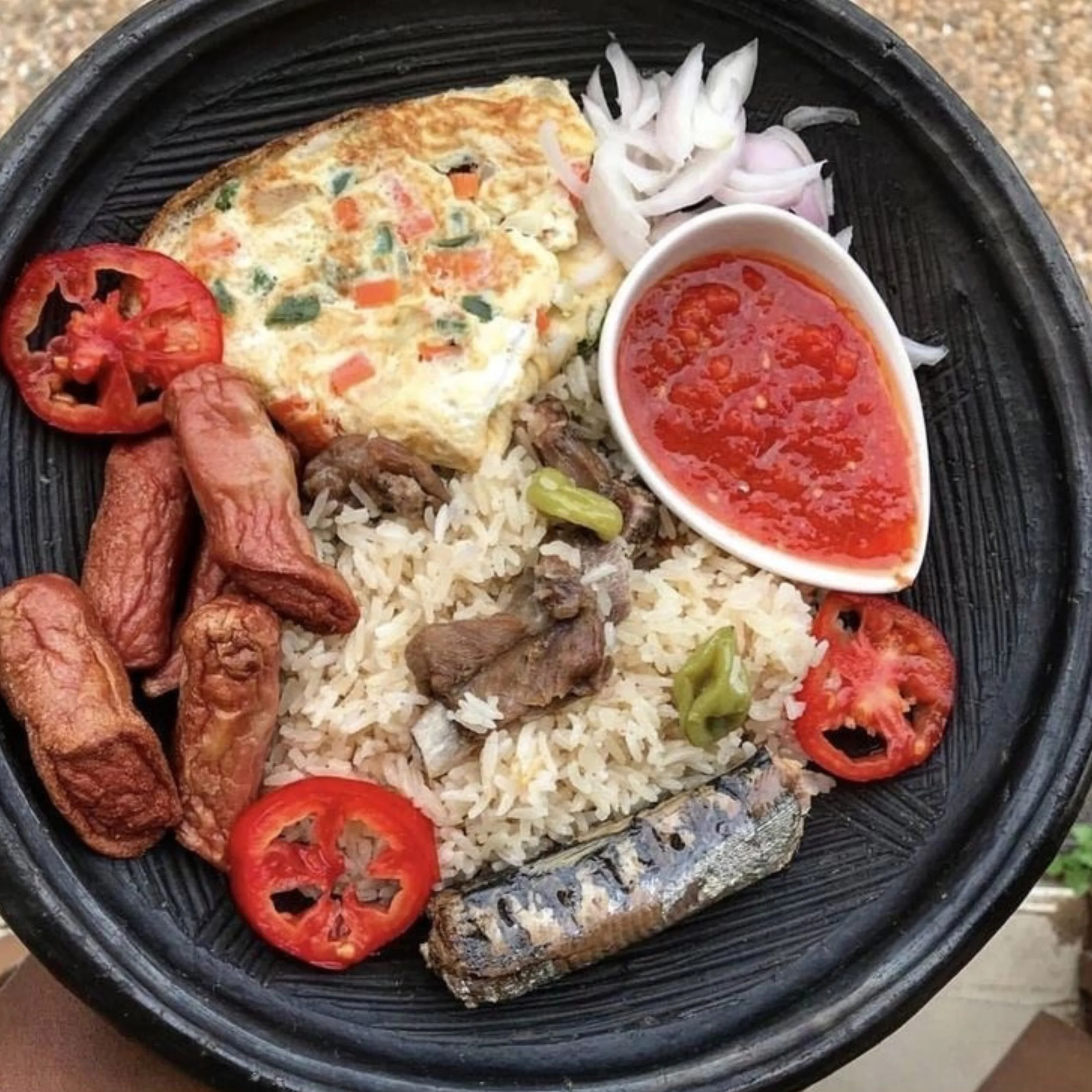 Nigerian jollof rice with assorted meats and vegetables