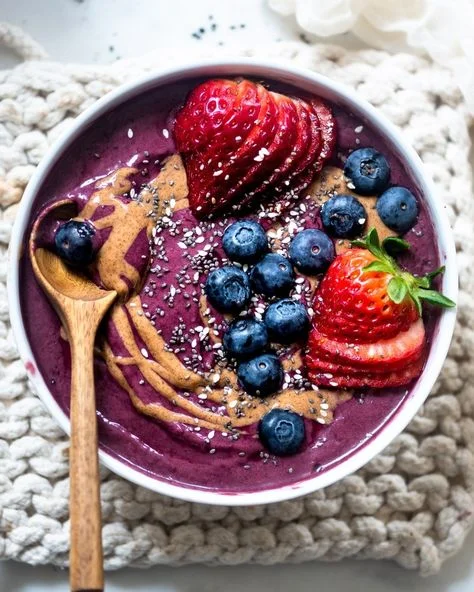 Acai bowl topped with fresh berries and nut butter