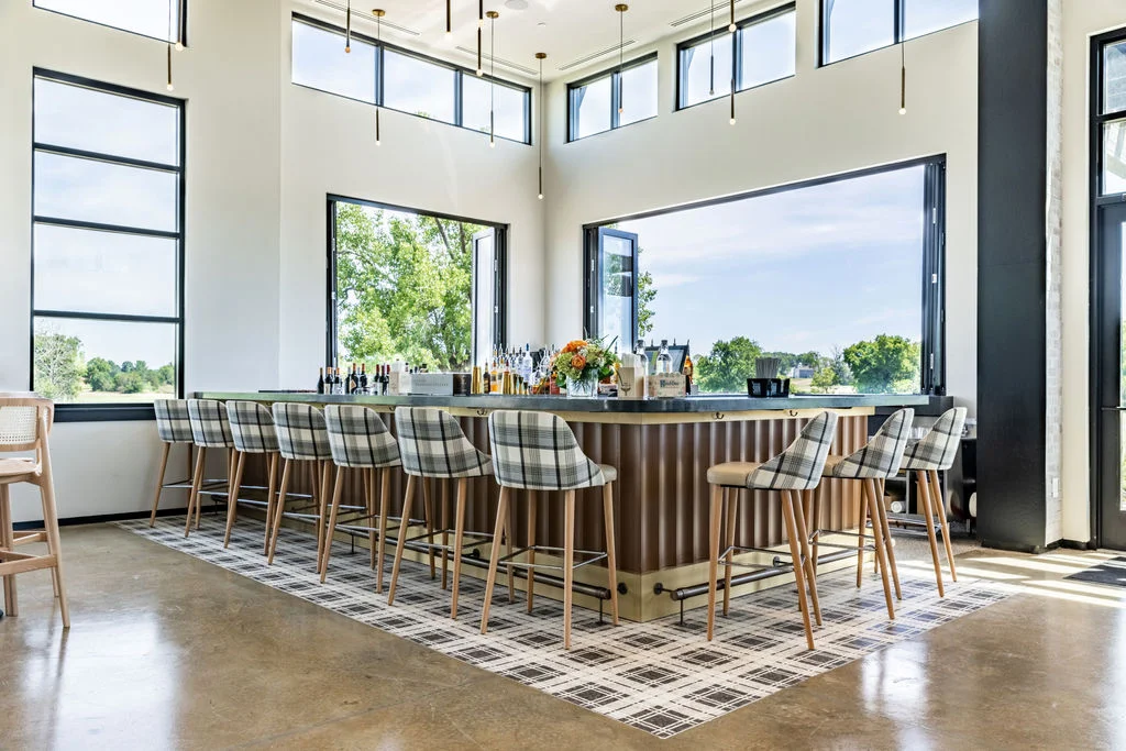 Modern bar interior with large windows and stylish seating