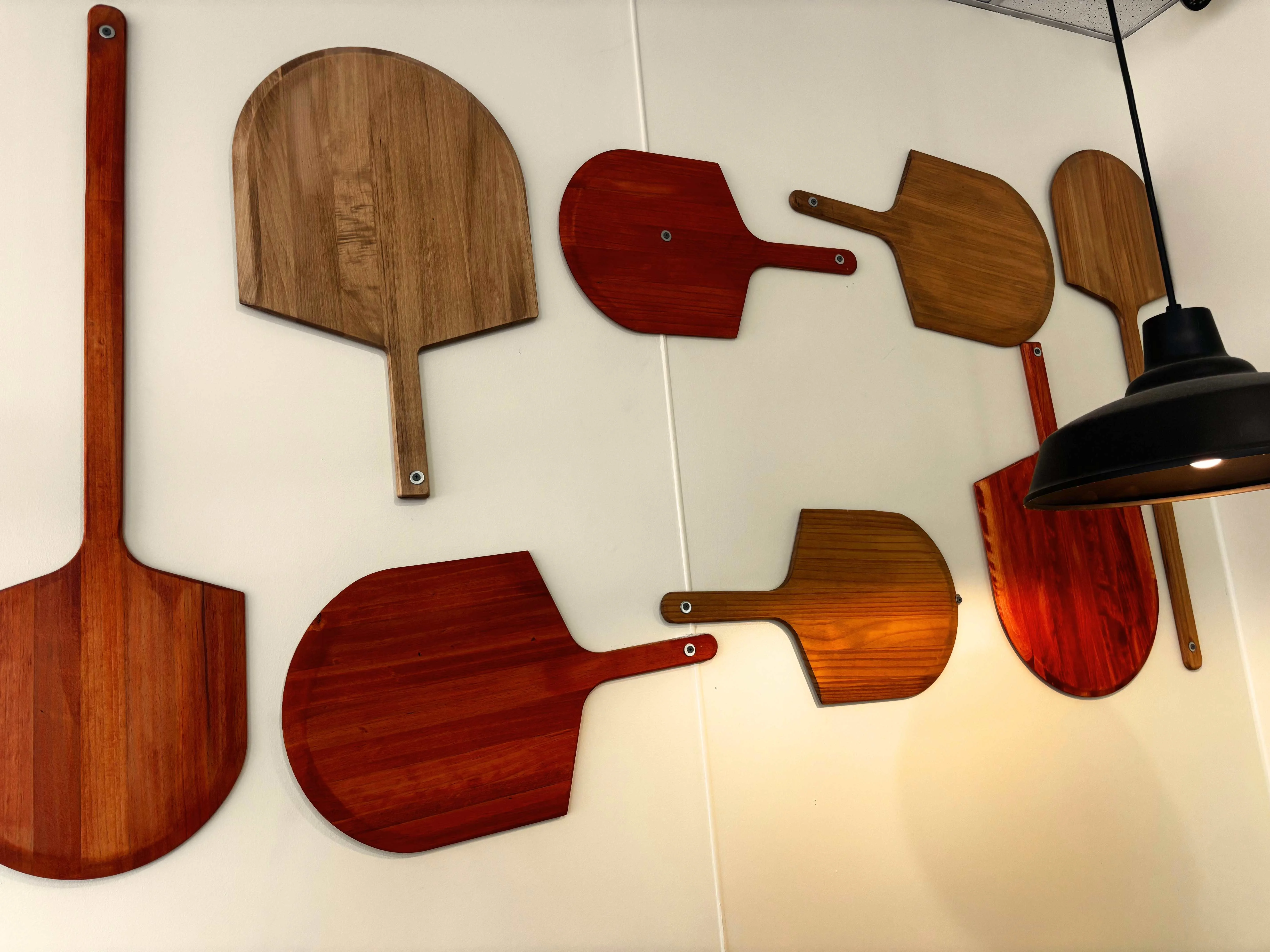 Decorative wooden pizza peels on restaurant wall