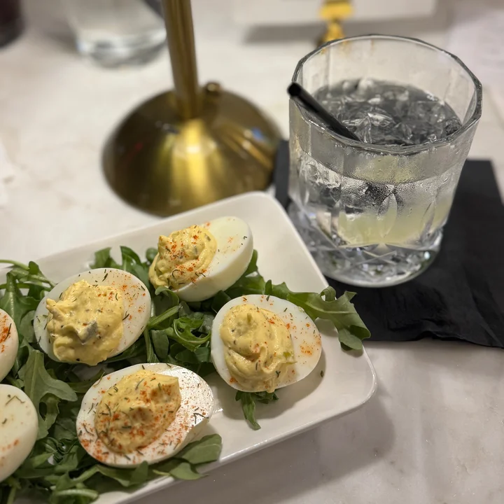 Classic deviled eggs served on arugula