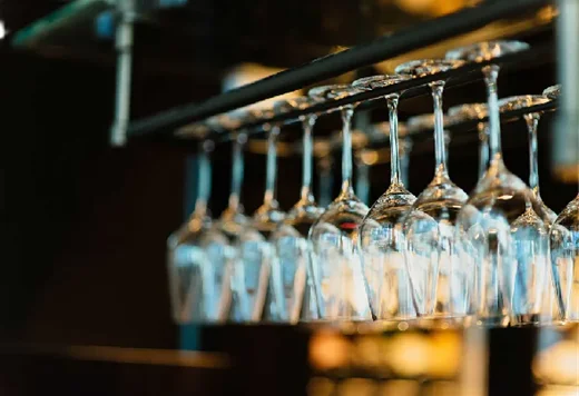 Elegant wine glasses hanging in a modern bar