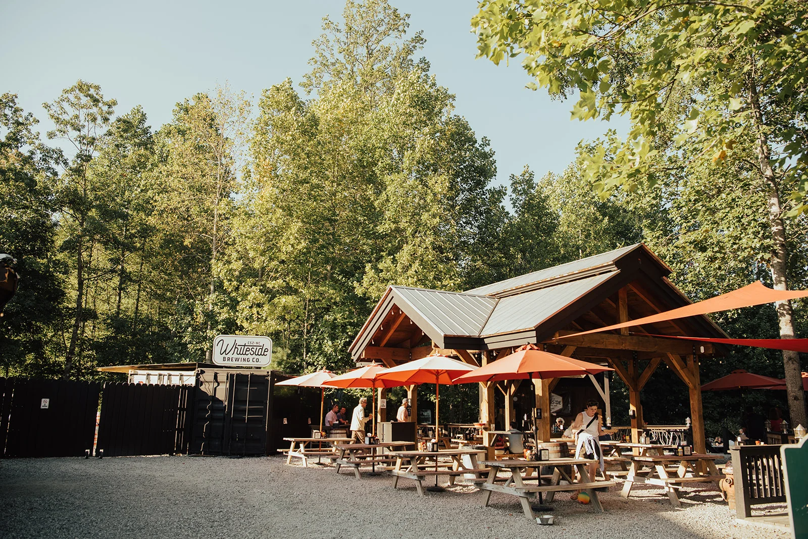 Outdoor brewery with picnic tables and umbrellas