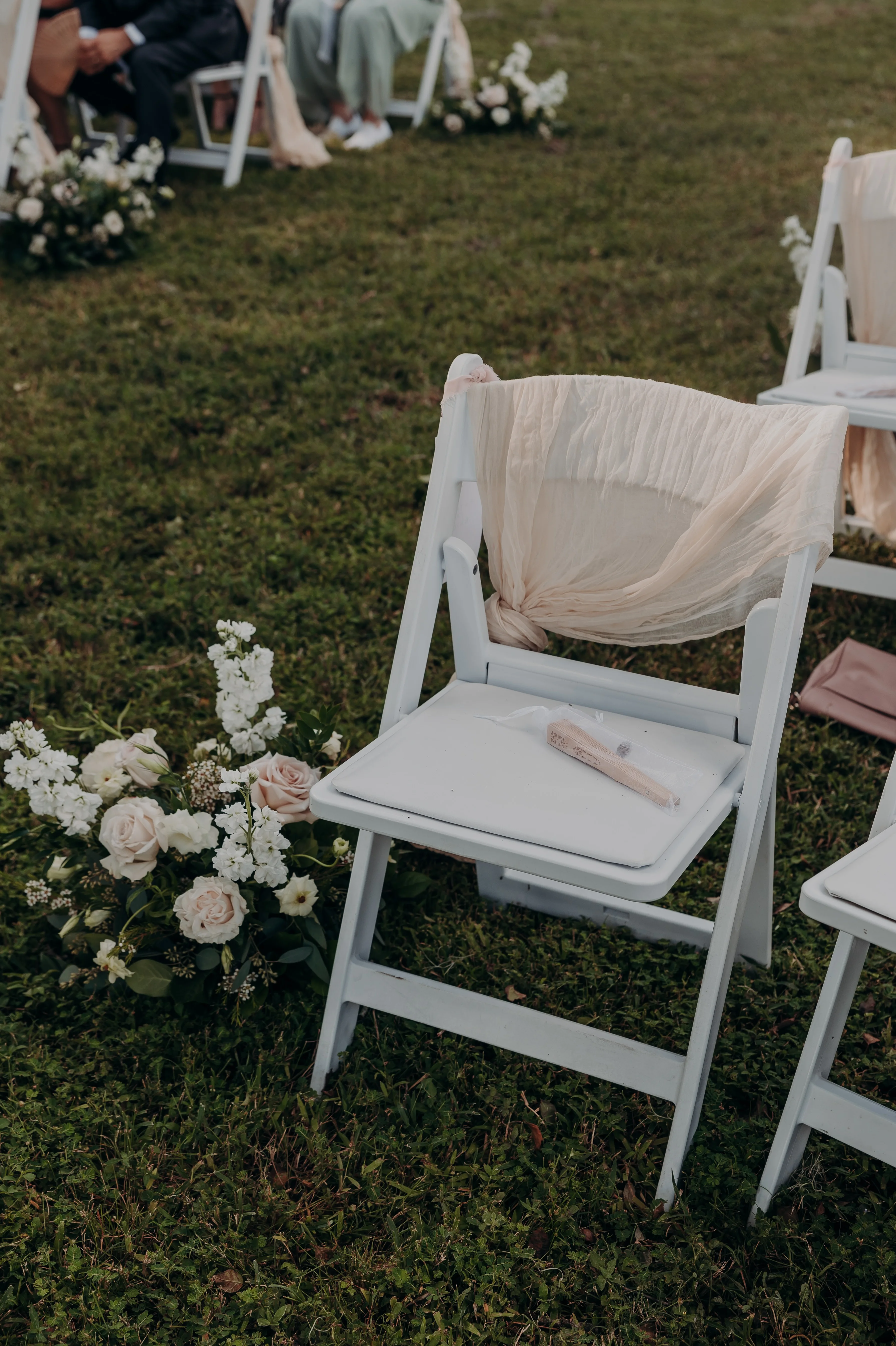 Elegant wedding chair with floral decor and soft draping fabric