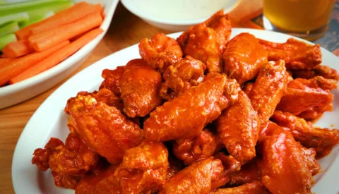 Spicy buffalo chicken wings served with celery and carrots