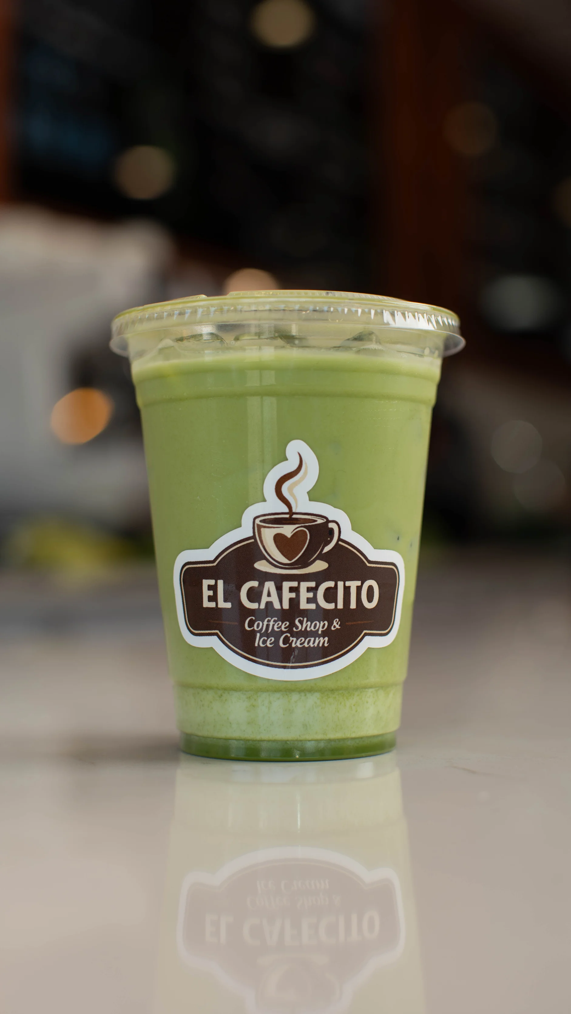 Green beverage in a cup from El Cafecito coffee shop