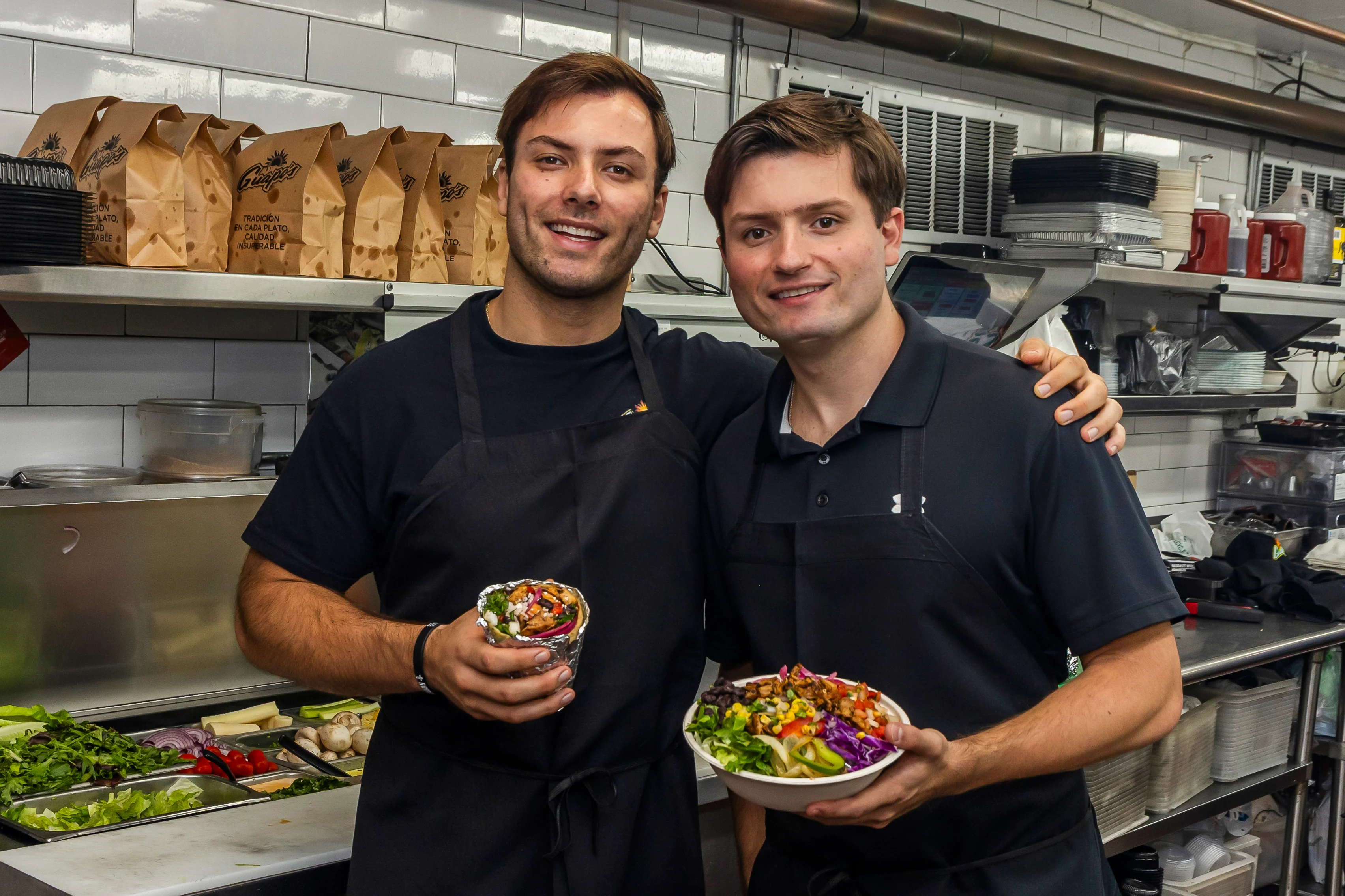 Chefs presenting vibrant Mediterranean grain bowls and wraps