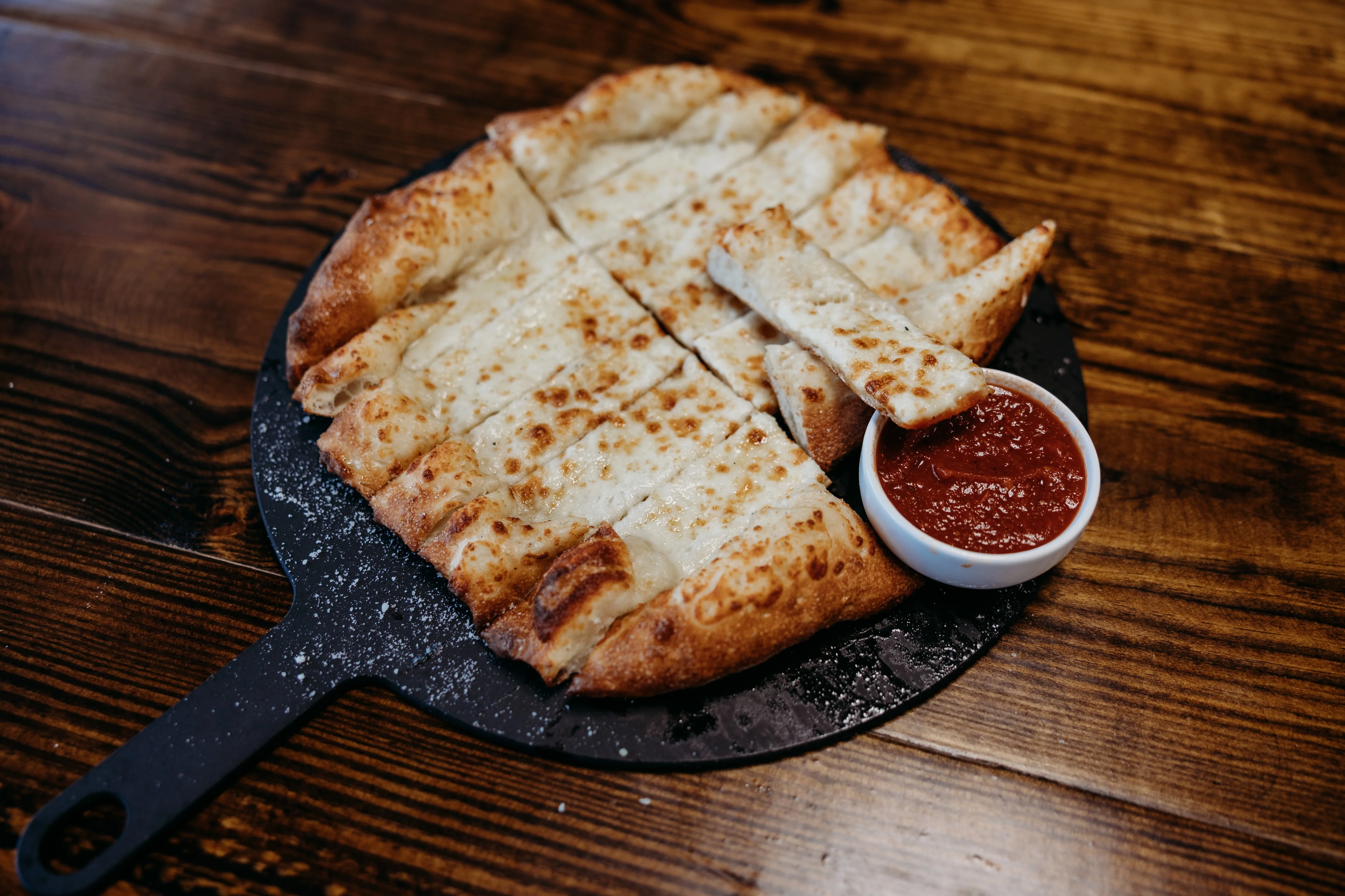 Cheesy garlic bread served with marinara sauce