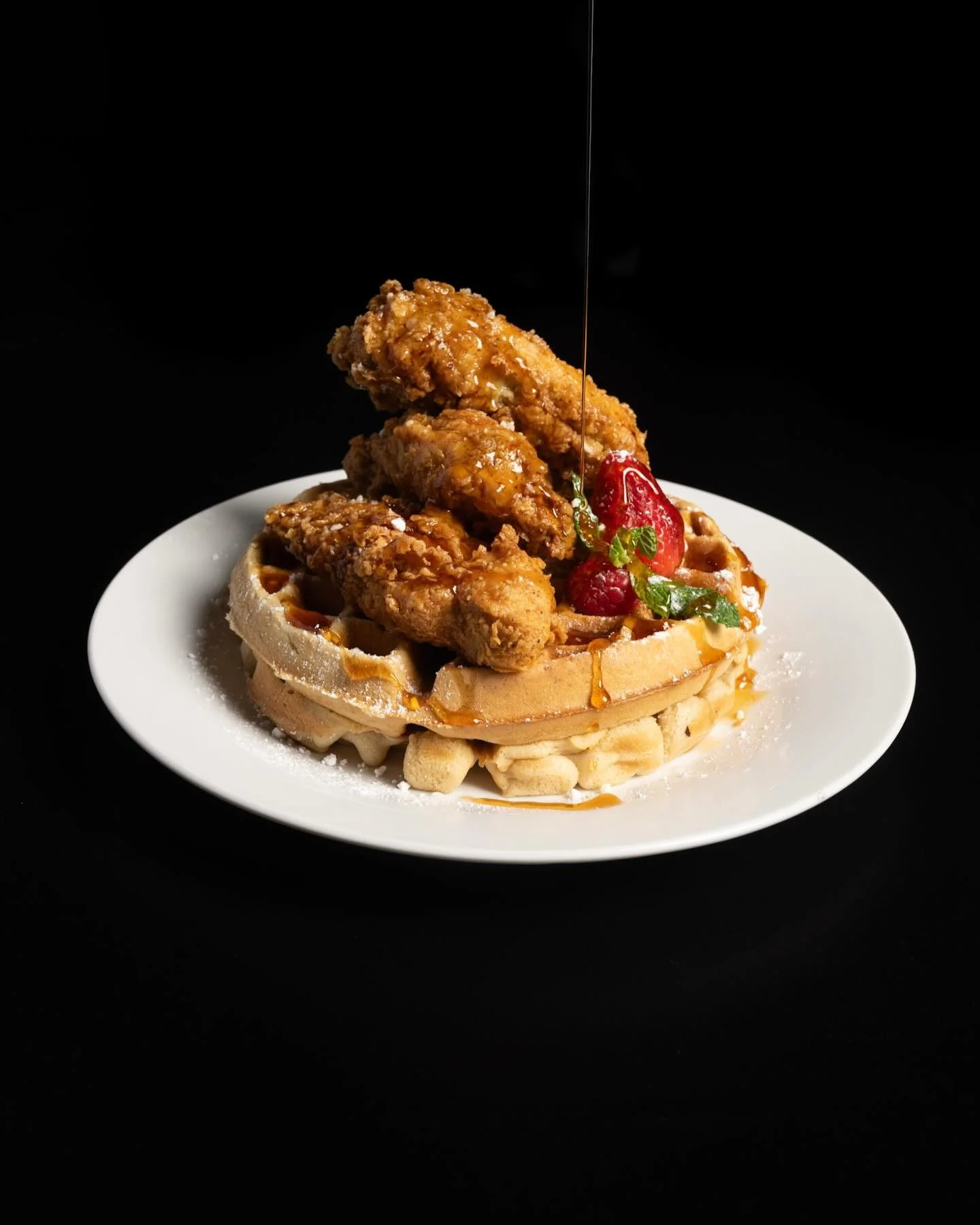 Southern chicken and waffles drizzled with syrup