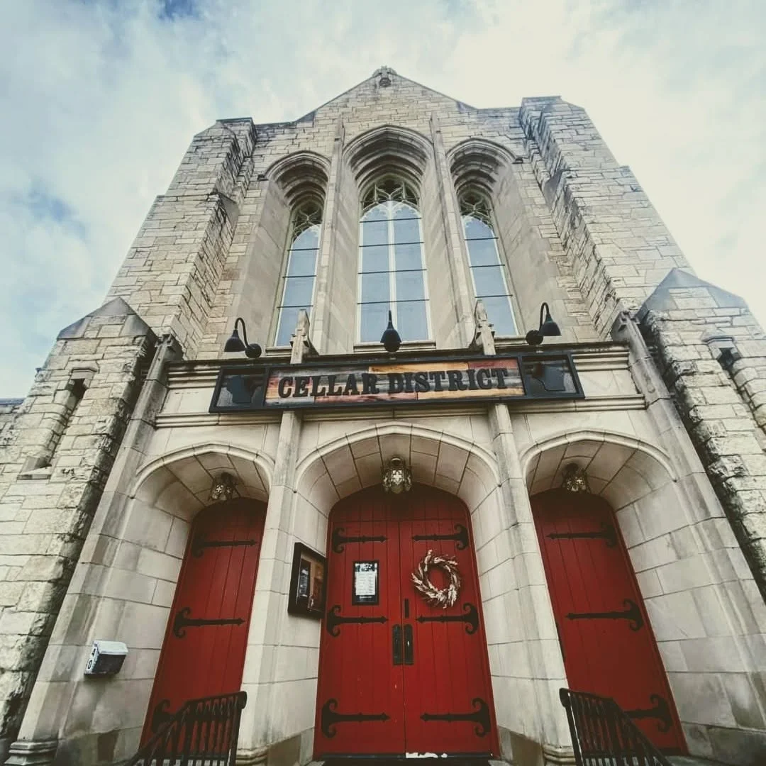 Historic restaurant entrance with red doors and stone architecture