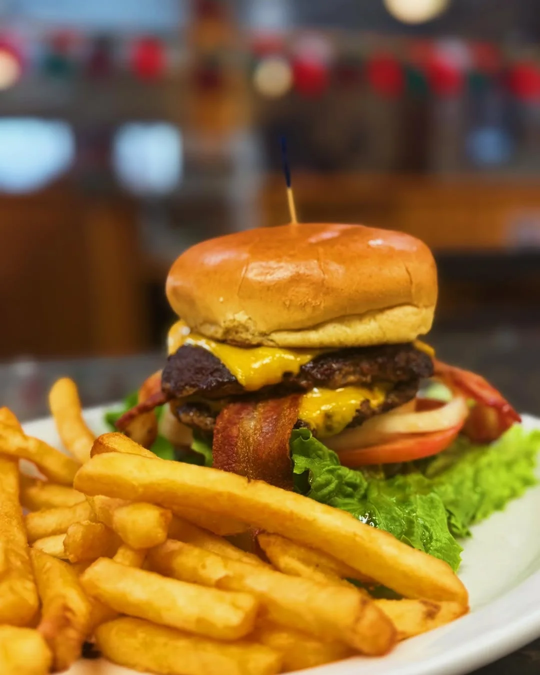 Juicy cheeseburger with bacon and fries