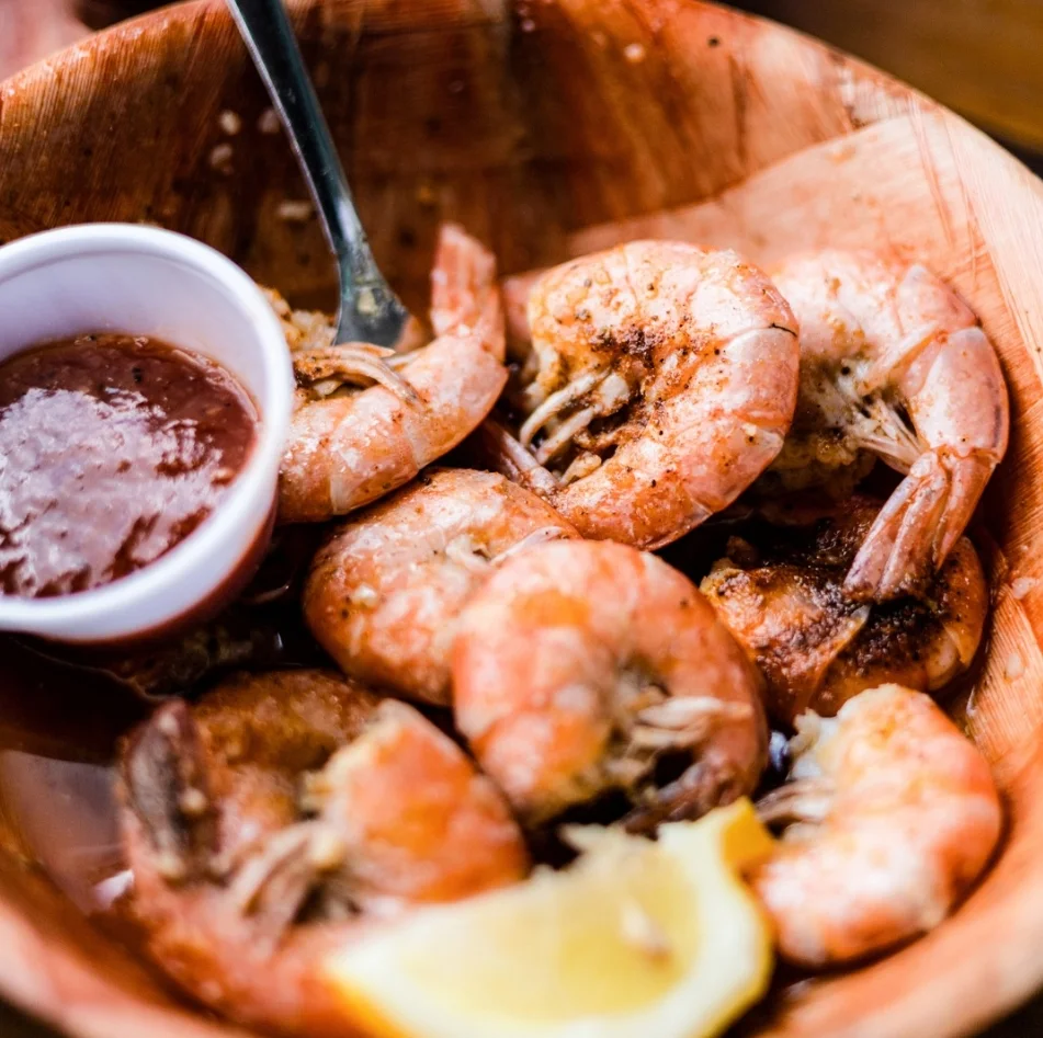 Steamed peel-and-eat shrimp served with cocktail sauce and lemon at Tarks of Dania in Dania Beach, Florida