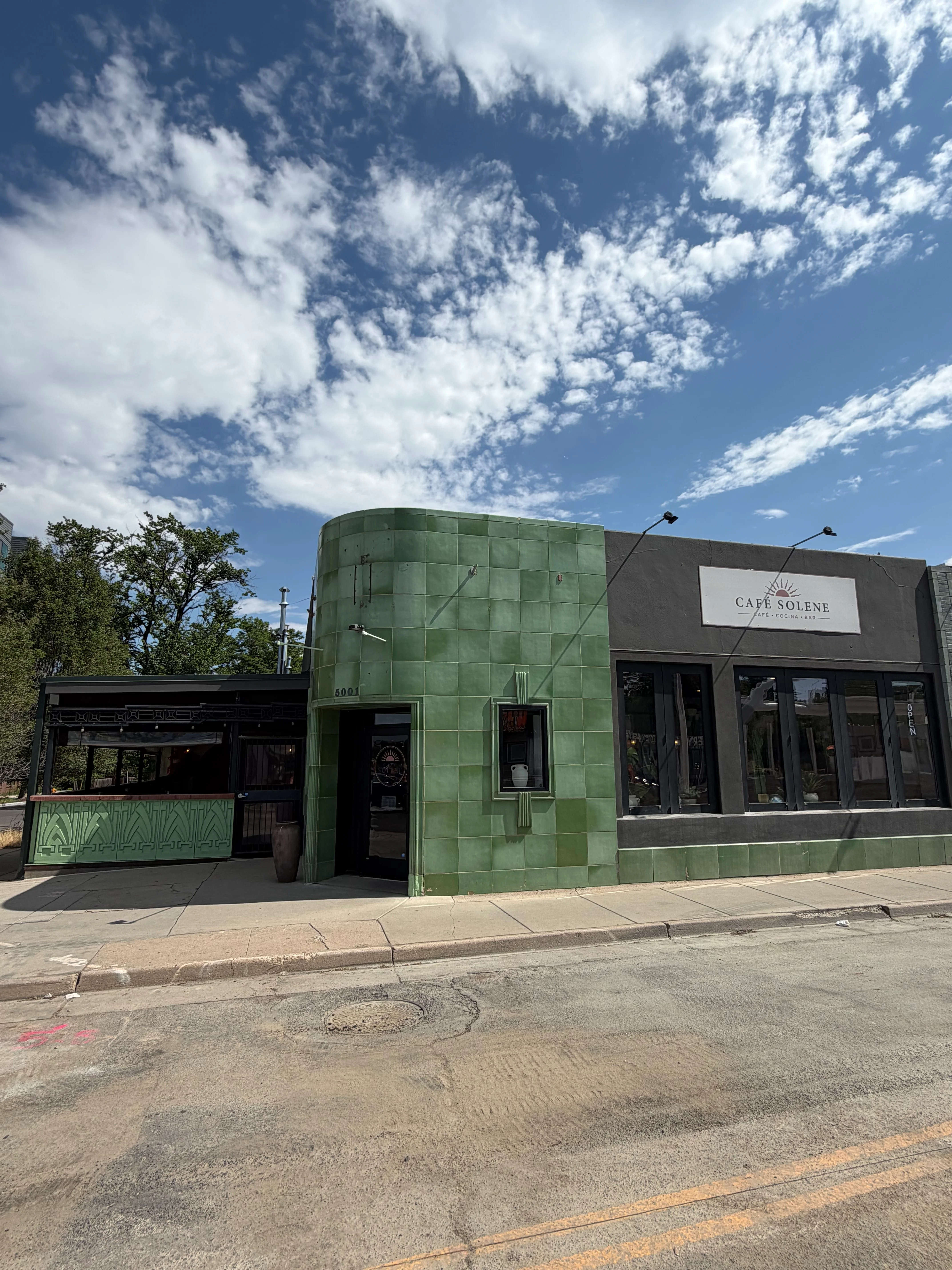 Exterior view of Café Solene with green tiles and modern design