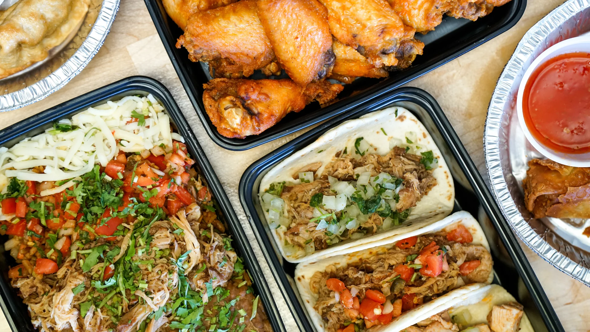 Delicious Mexican tacos with pulled pork and crispy chicken wings