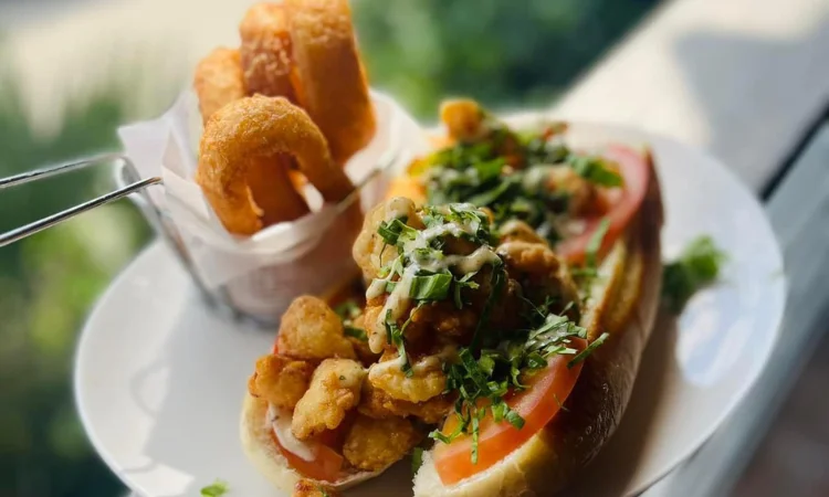 Cajun shrimp po' boy sandwich with crispy sides