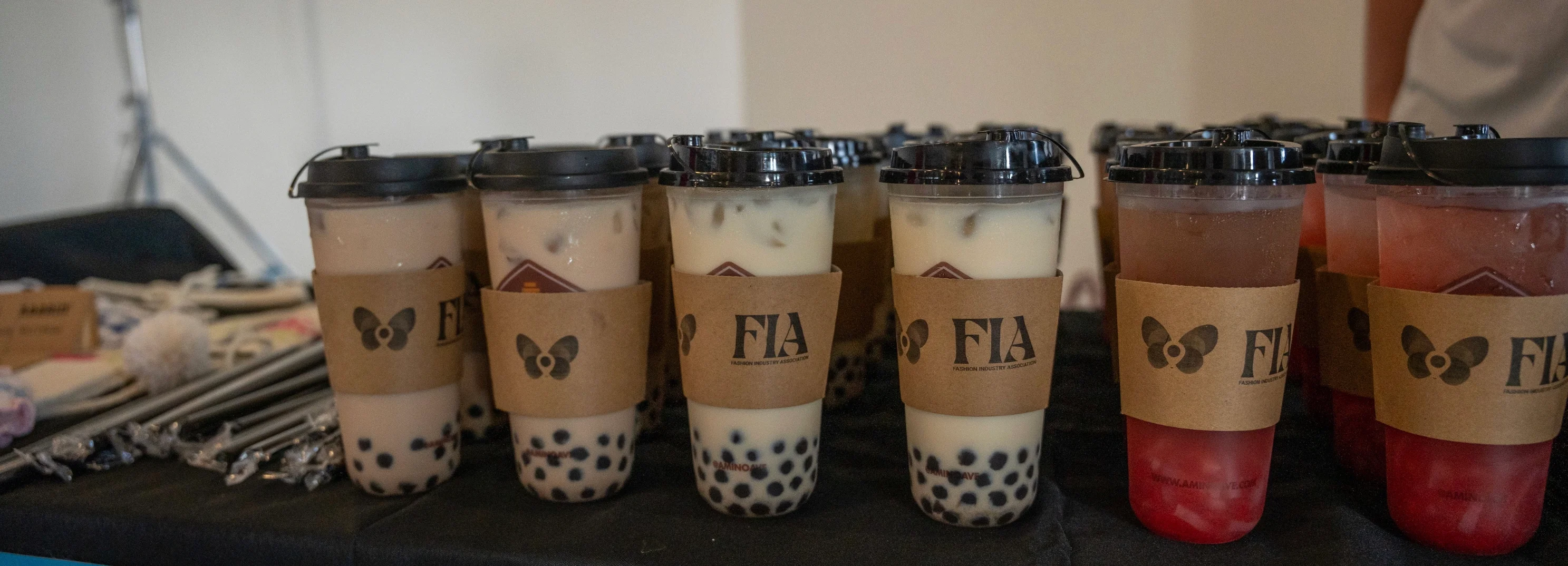 Assorted bubble tea drinks in clear cups with lids