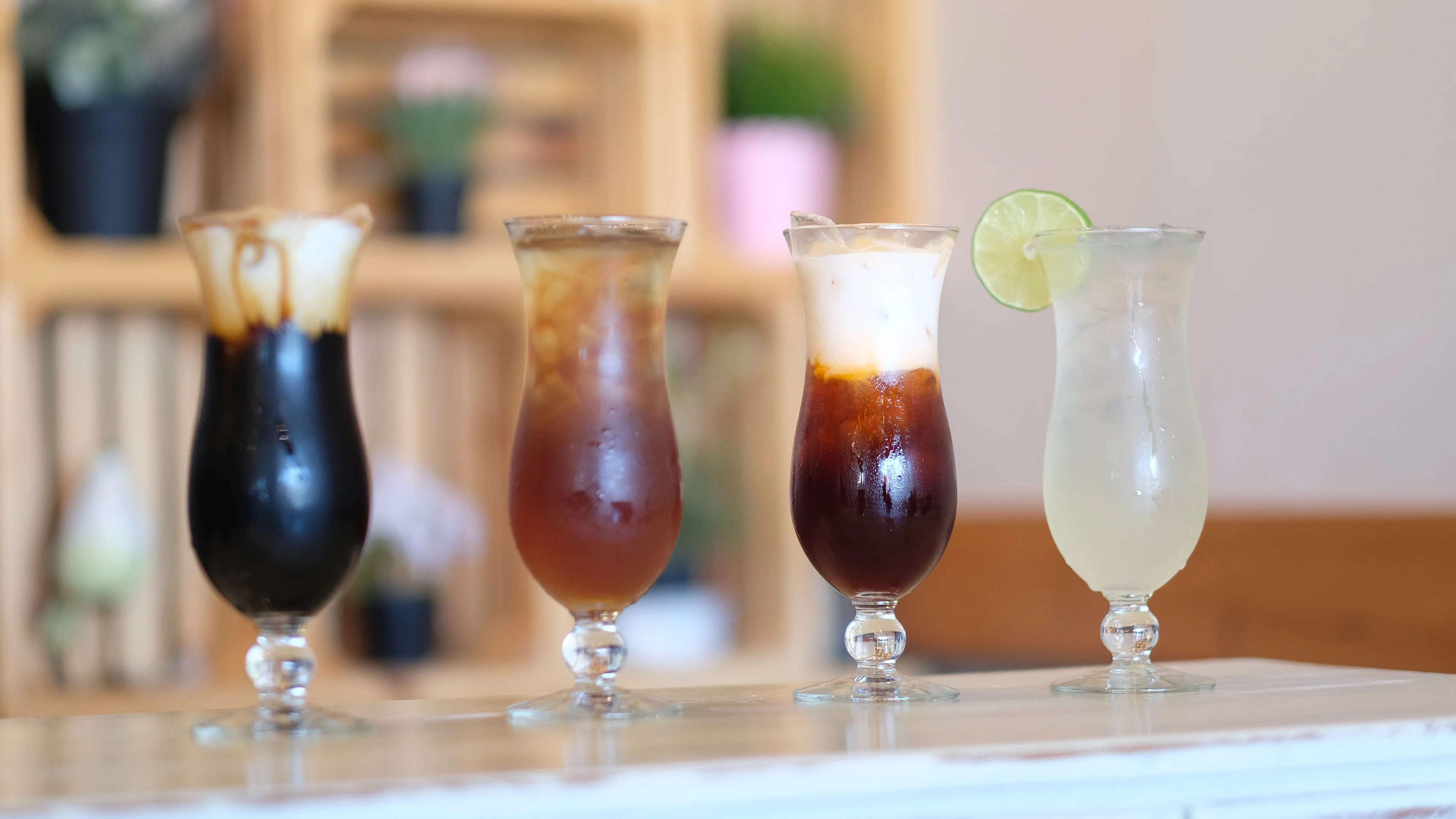 Assorted iced coffee drinks in elegant glasses