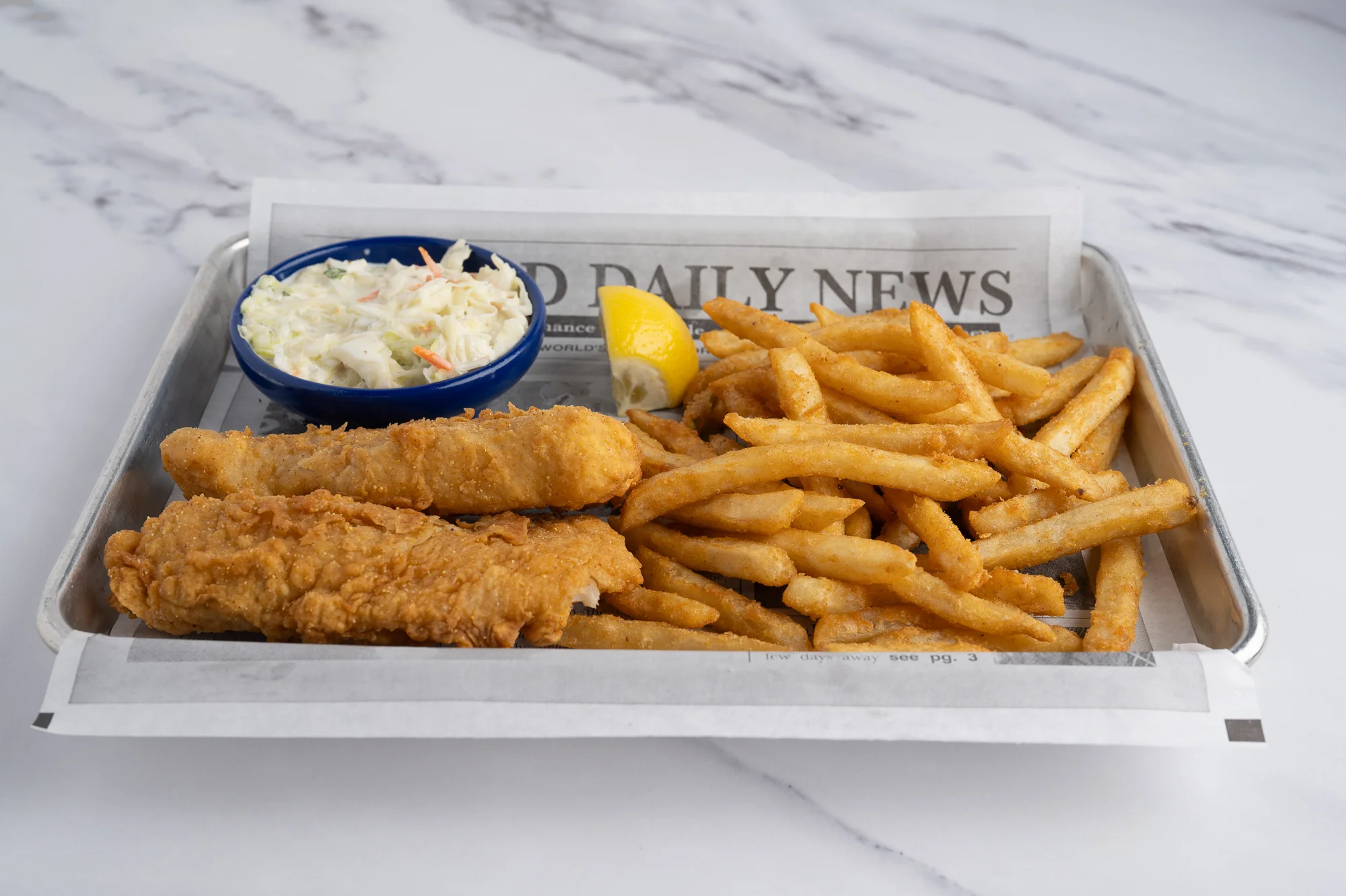 Classic fish and chips served with coleslaw and lemon wedge
