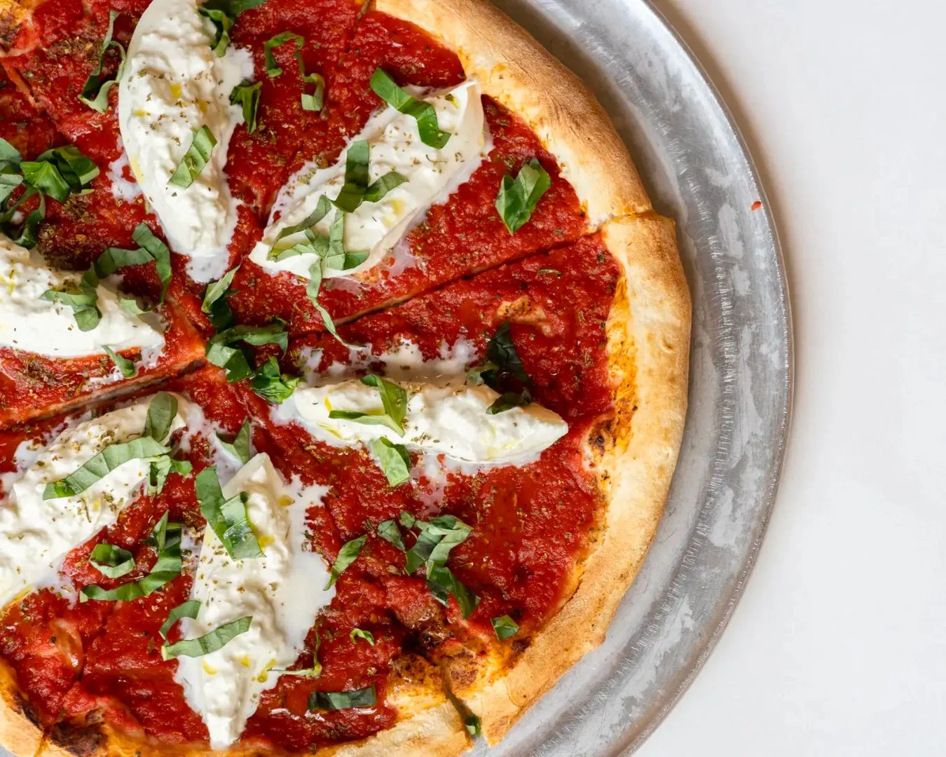 Classic Margherita pizza with fresh basil and creamy mozzarella
