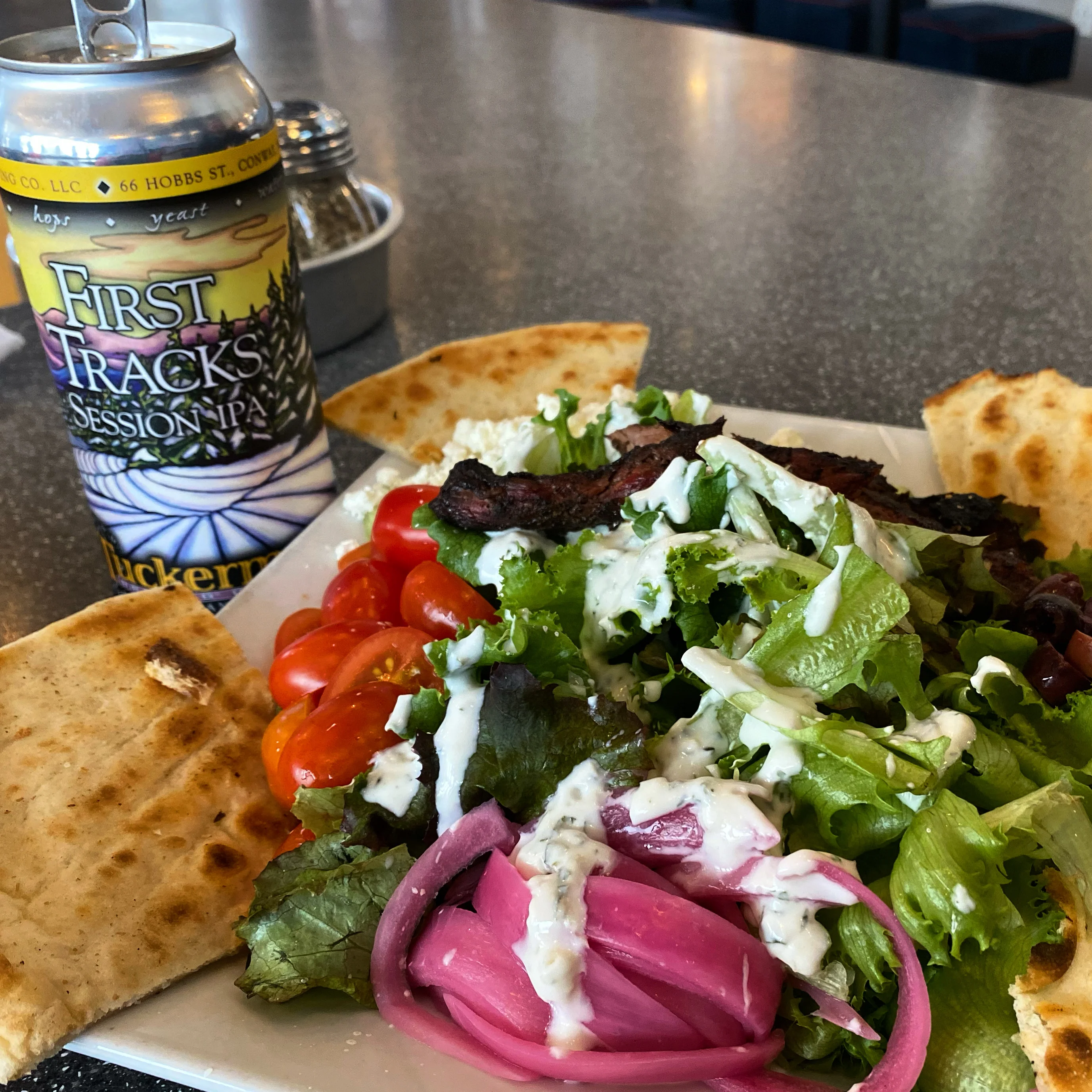 Mediterranean salad with grilled meat and pita bread