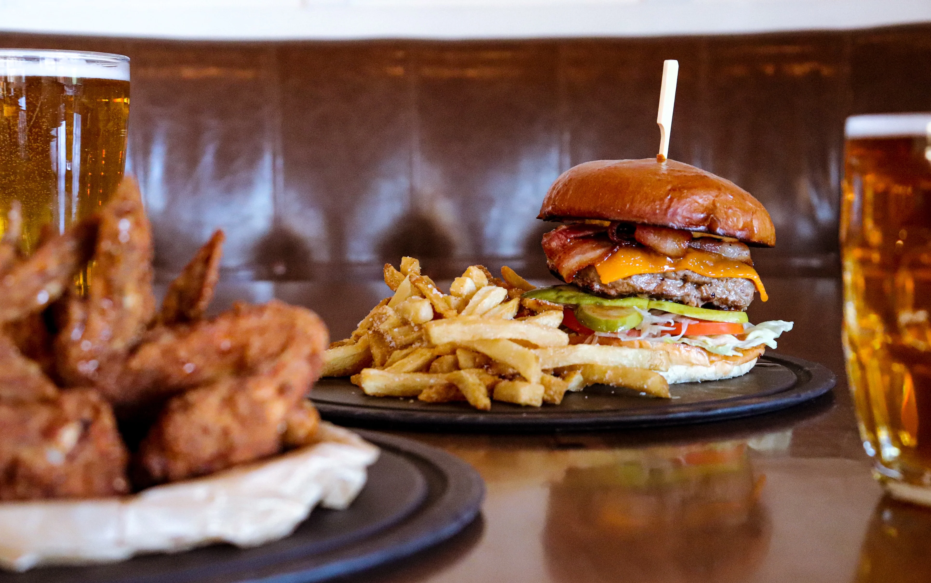 Juicy cheeseburger with fries and craft beer