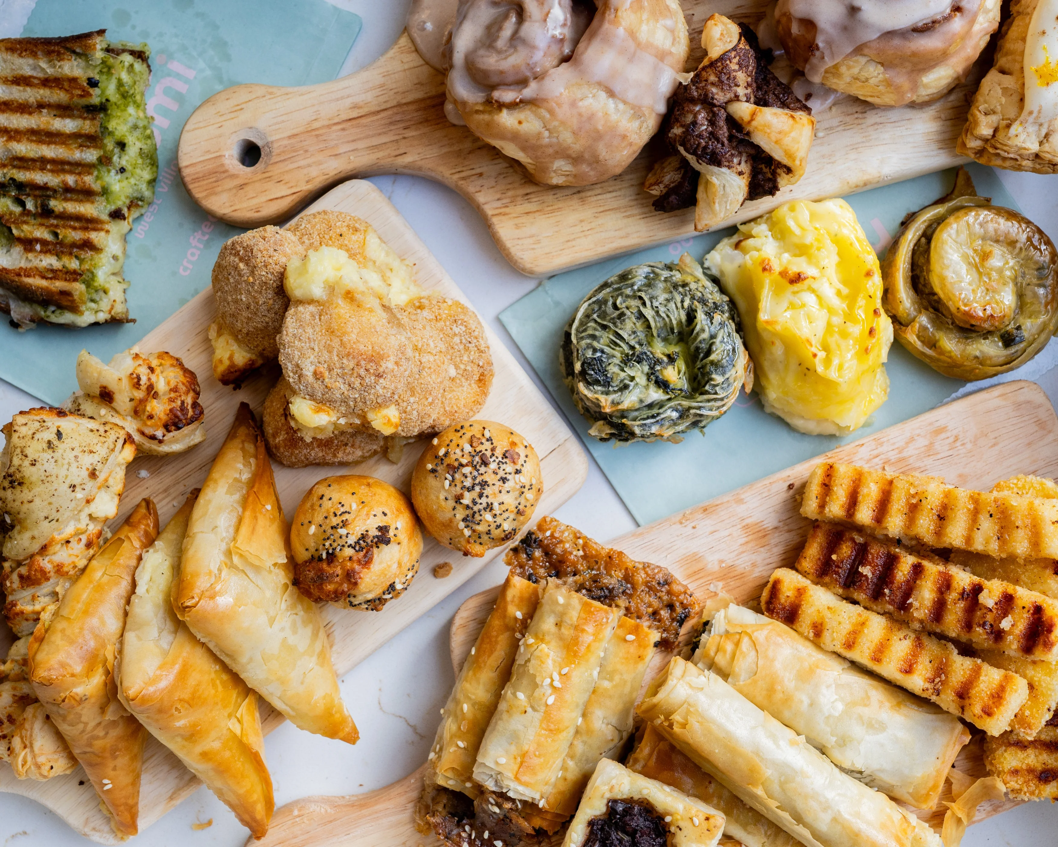 Assorted Mediterranean pastries and baked goods on wooden boards