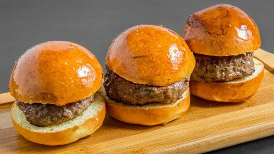 Three classic American hamburgers on brioche buns