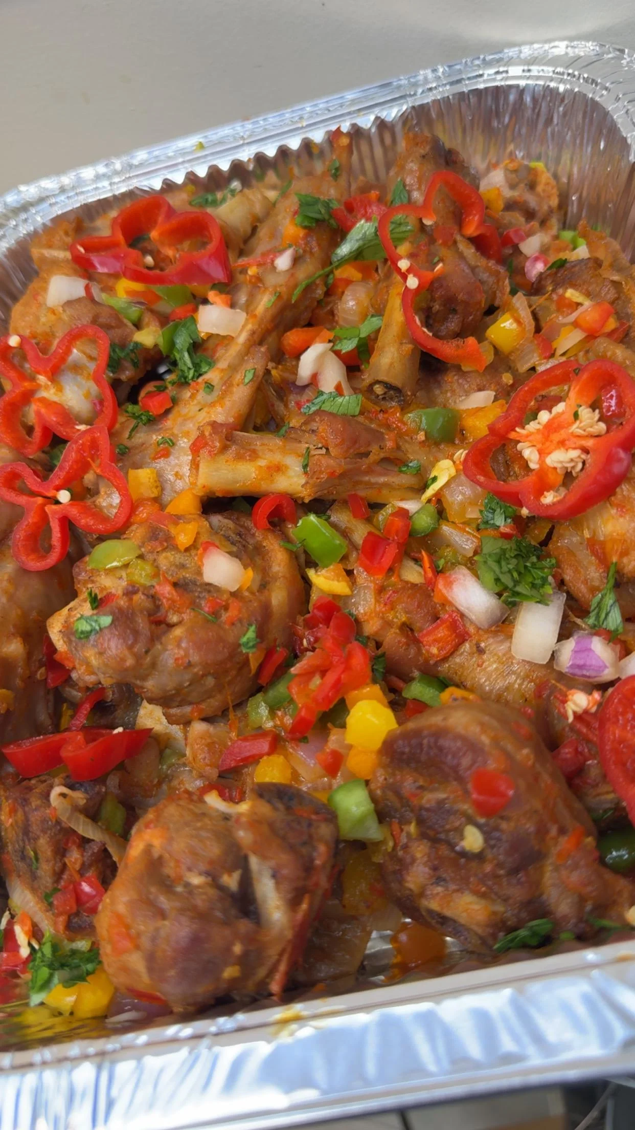 Jamaican jerk chicken with colorful peppers and herbs