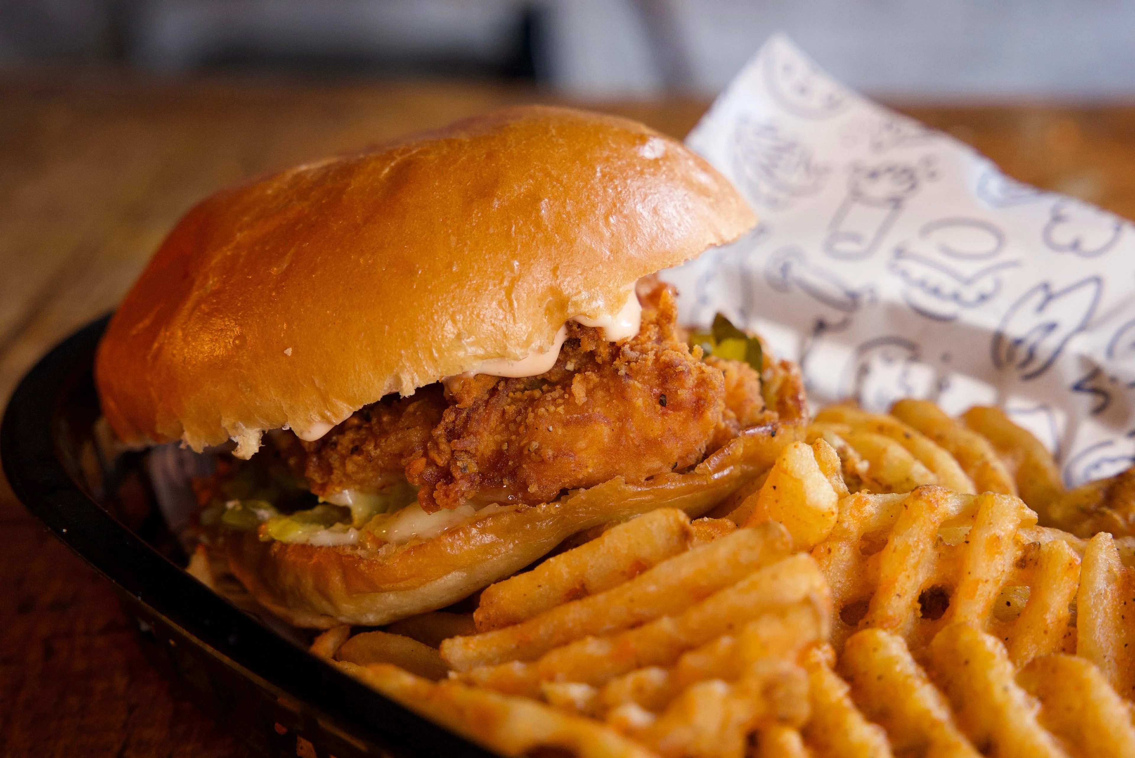 Crispy fried chicken sandwich with waffle fries