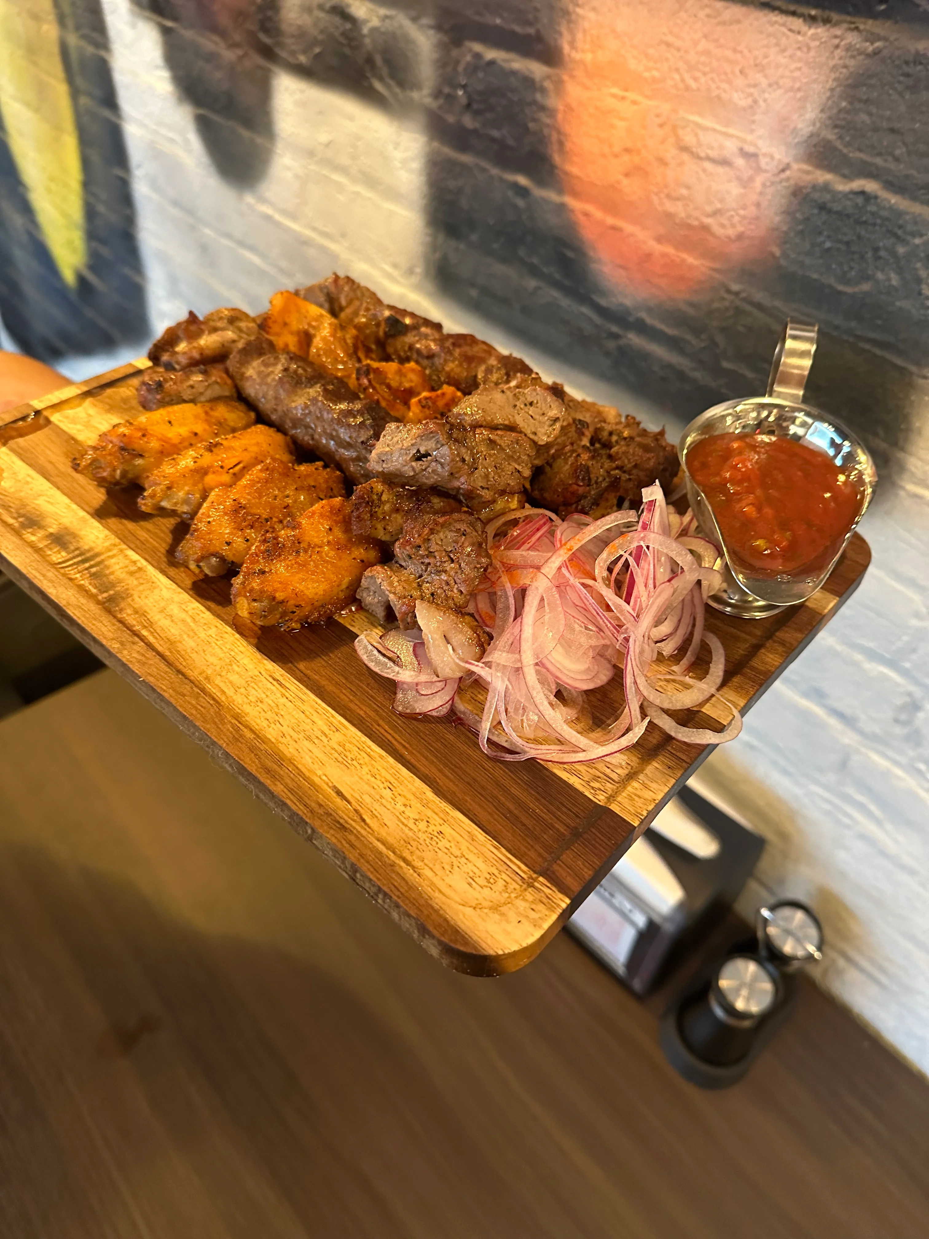 Chicken, Lamb, and Beef Shashlik served on a rustic cutting board at Samarkand Nights Uzbek restaurant Brooklyn