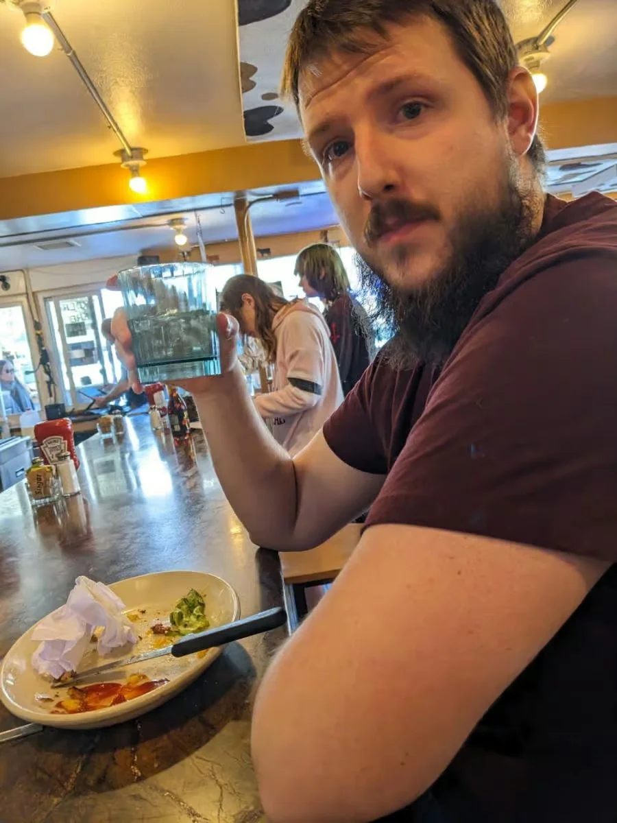 Casual dining scene with a man holding a glass of water