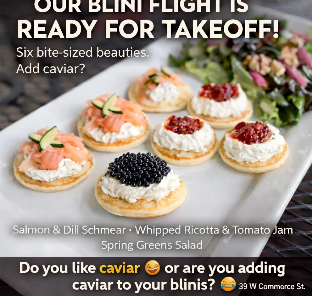 Delicious blini served with toppings on a wooden table.