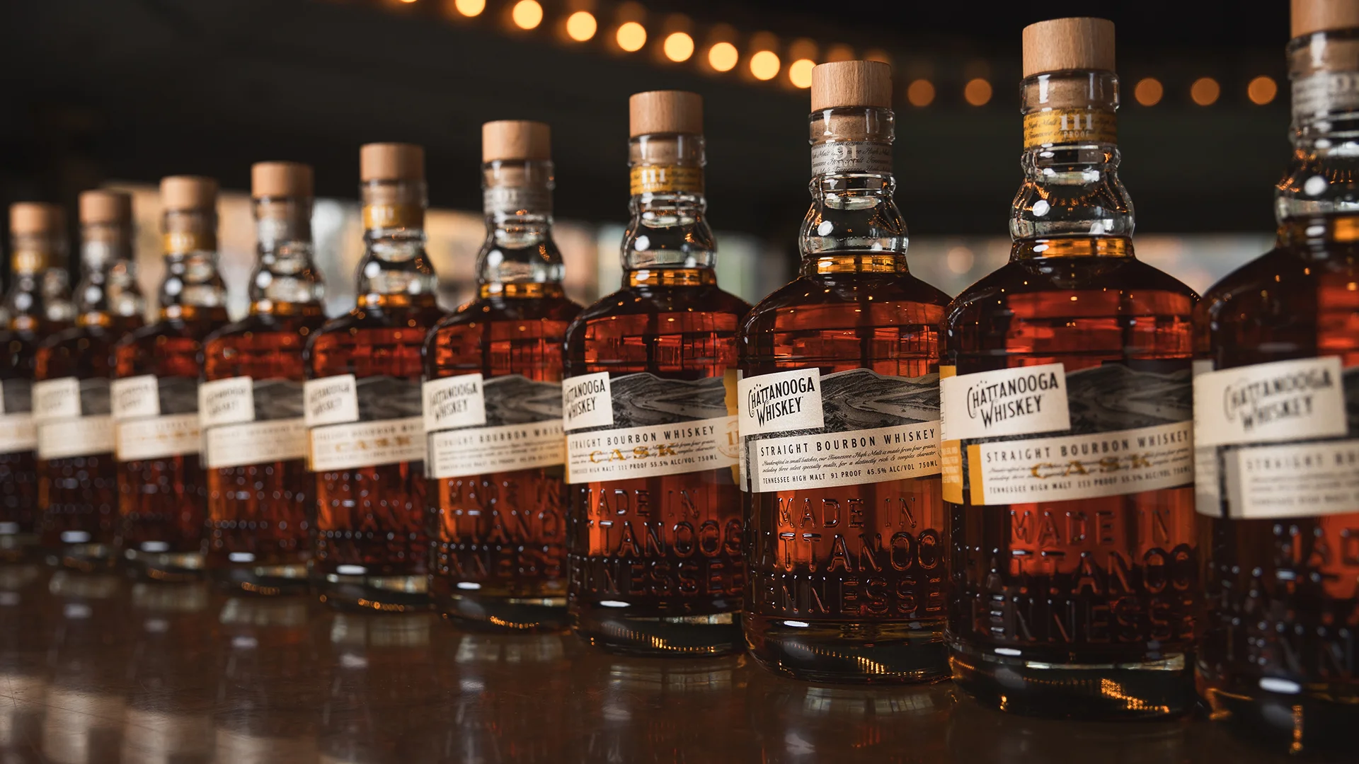 Collection of Chattanooga bourbon whiskey bottles on a bar