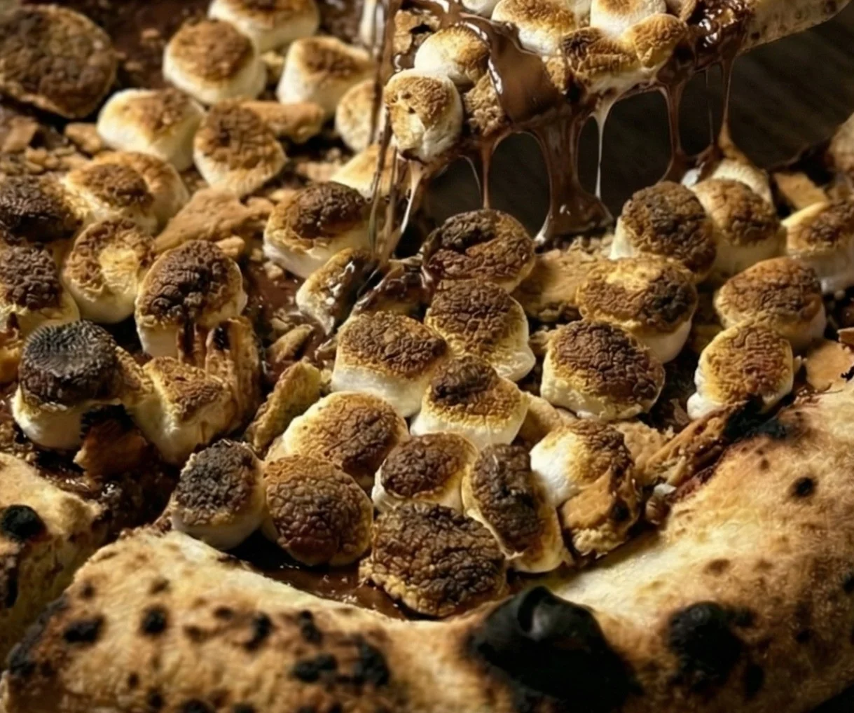 S'mores pizza with toasted marshmallows and chocolate