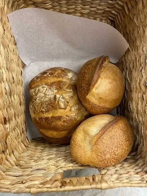 Artisan bread loaves in a woven basket