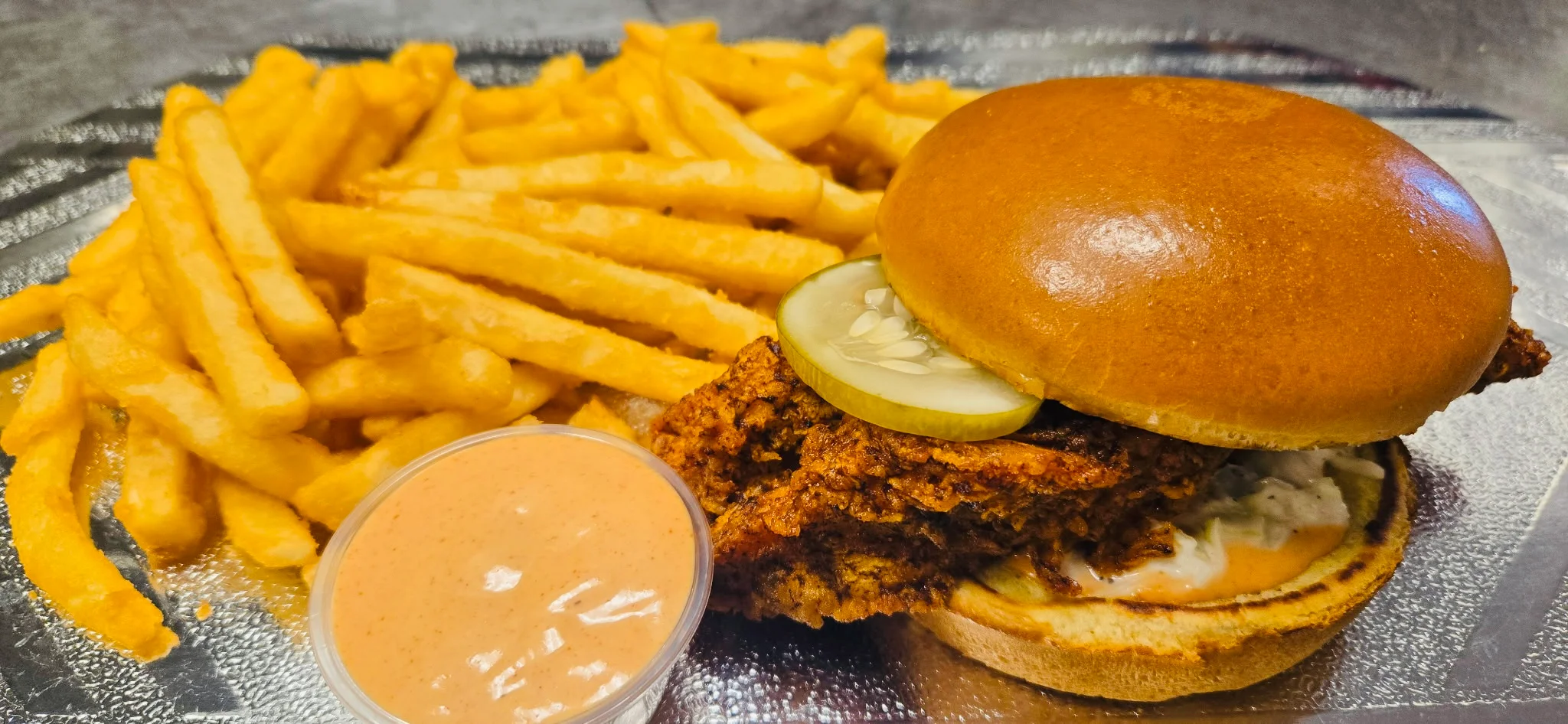 Crispy fried chicken sandwich with fries