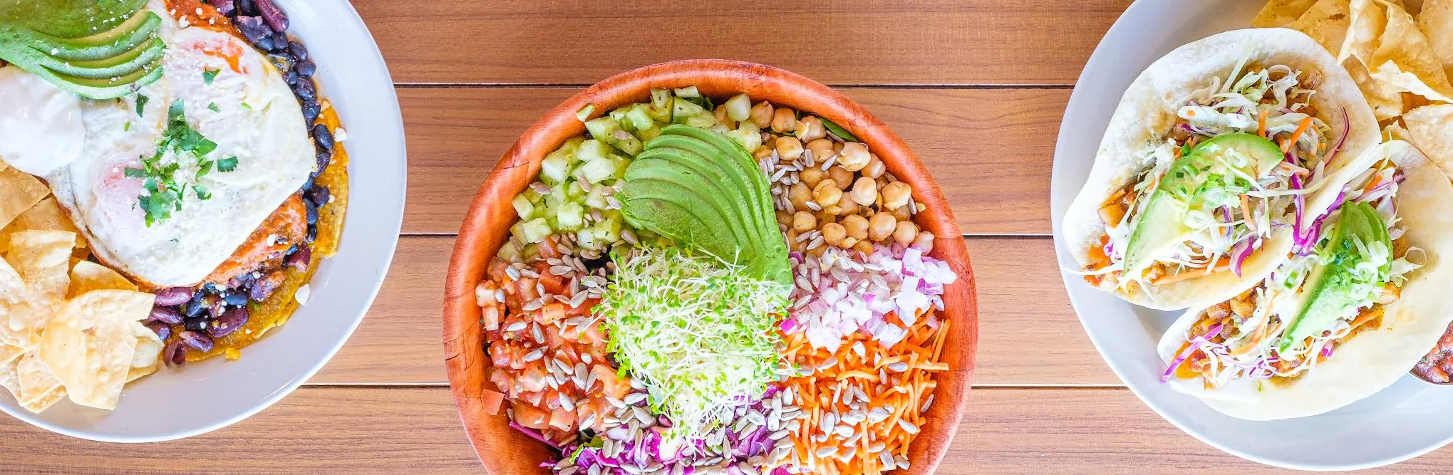 Colorful Mexican platter with tacos and a fresh salad bowl