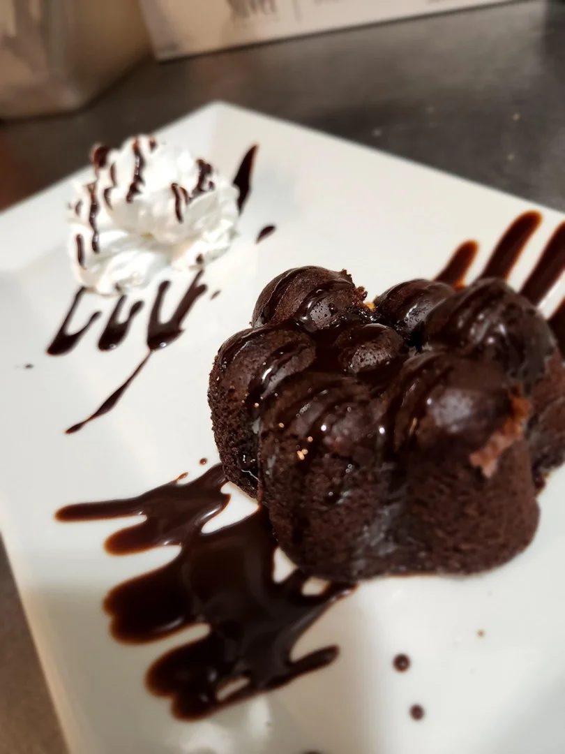 Decadent chocolate lava cake with whipped cream