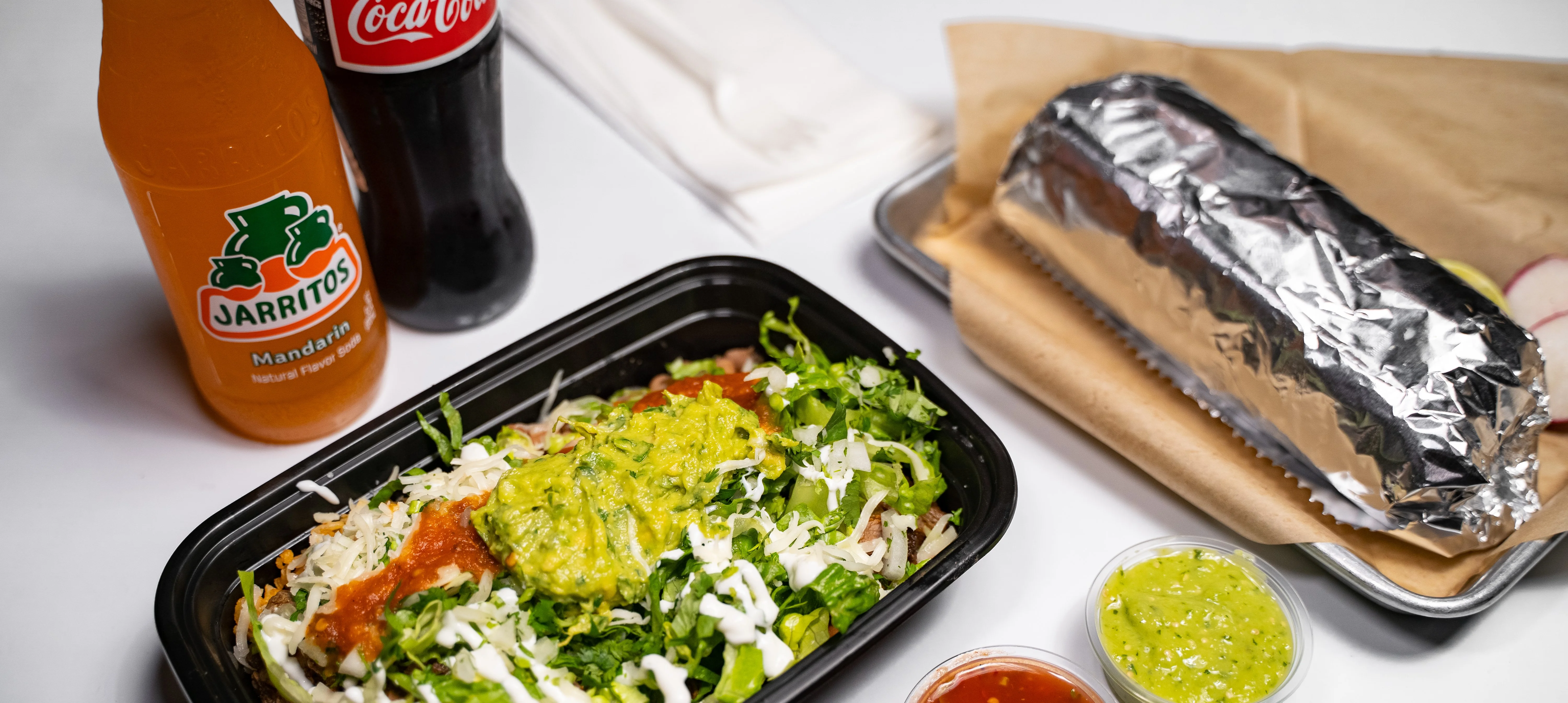 Delicious Mexican burrito with fresh toppings and drinks