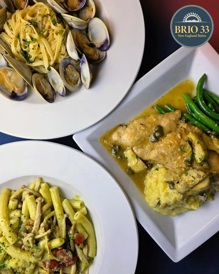 Pan-seared salmon with creamy sauce in a bustling restaurant kitchen