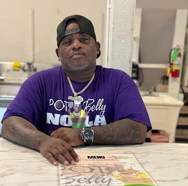 Restaurant owner showcasing menu at a vibrant eatery
