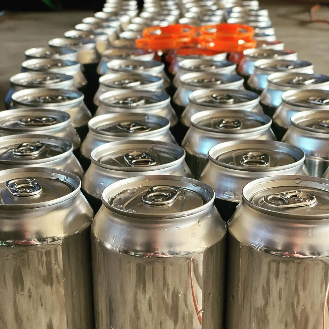 Row of aluminum cans ready for distribution