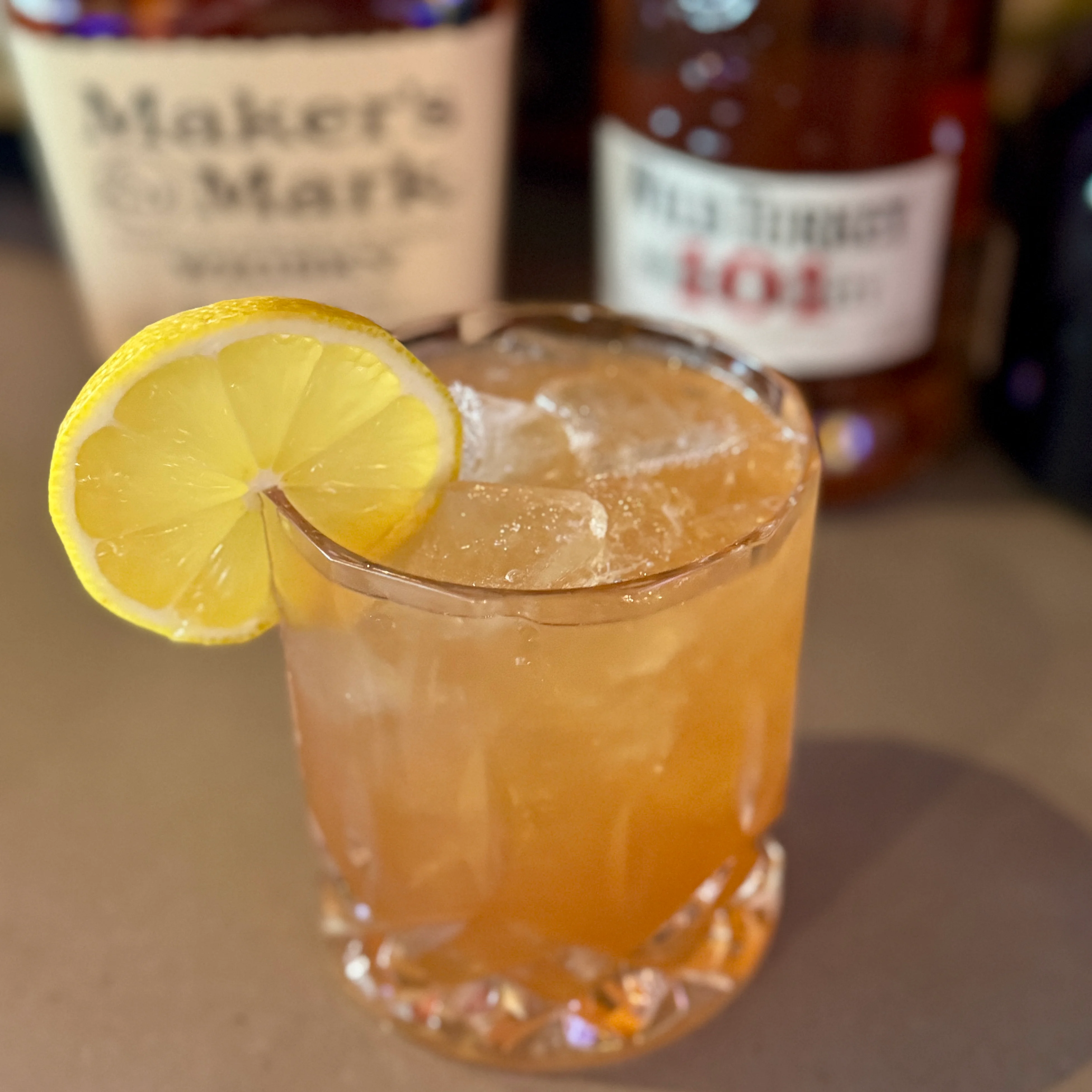 Refreshing bourbon cocktail with lemon garnish